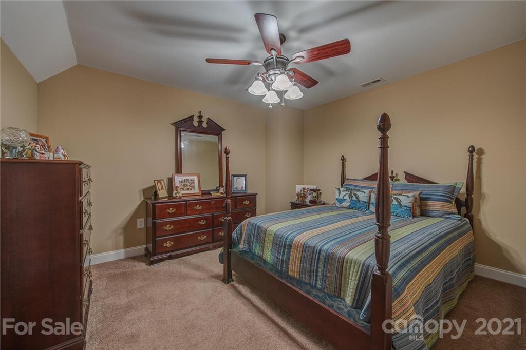 936 Ferguson Ridge Road Gastonia, NC 28052 - Photo 18 of 30 a bedroom with a bed and a chandelier
