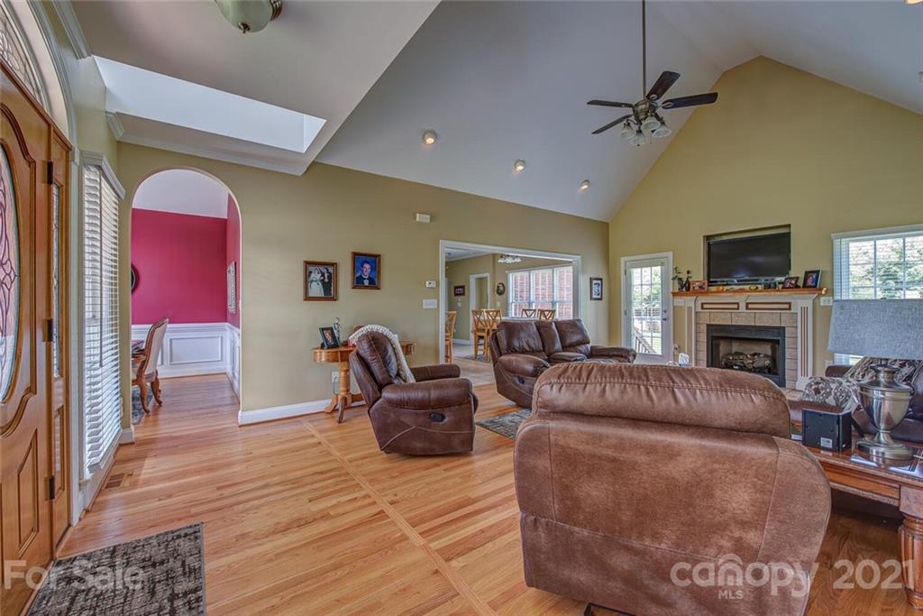 936 Ferguson Ridge Road Gastonia, NC 28052 - Photo 5 of 30 a living room with furniture a fireplace and a flat screen tv