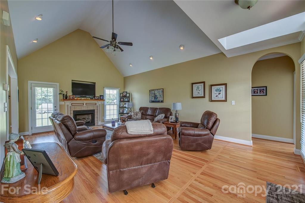936 Ferguson Ridge Road Gastonia, NC 28052 - Photo 6 of 30 a living room with furniture a fireplace and a flat screen tv