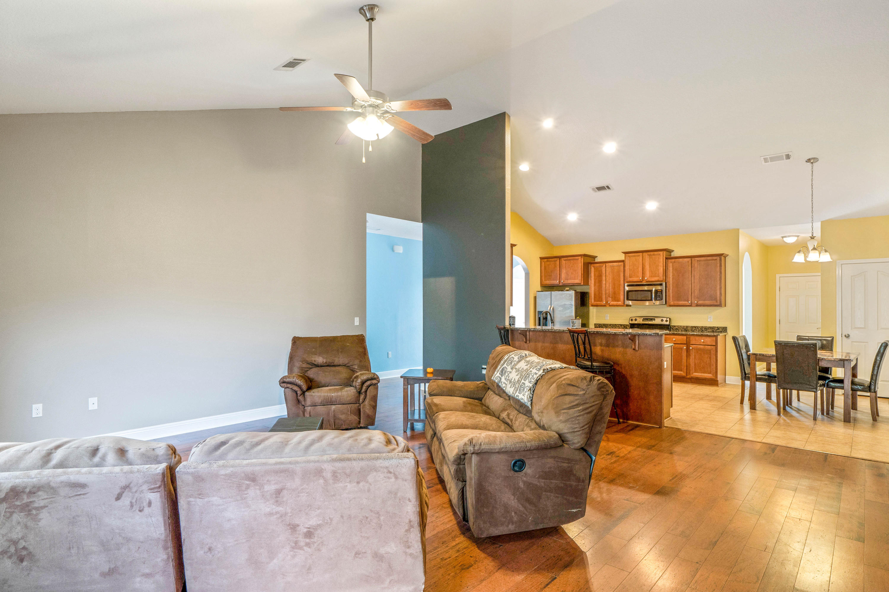 627 Red Fern Road Crestview, FL 32536 - Photo 11 of 29 a living room with kitchen island furniture and a chandelier