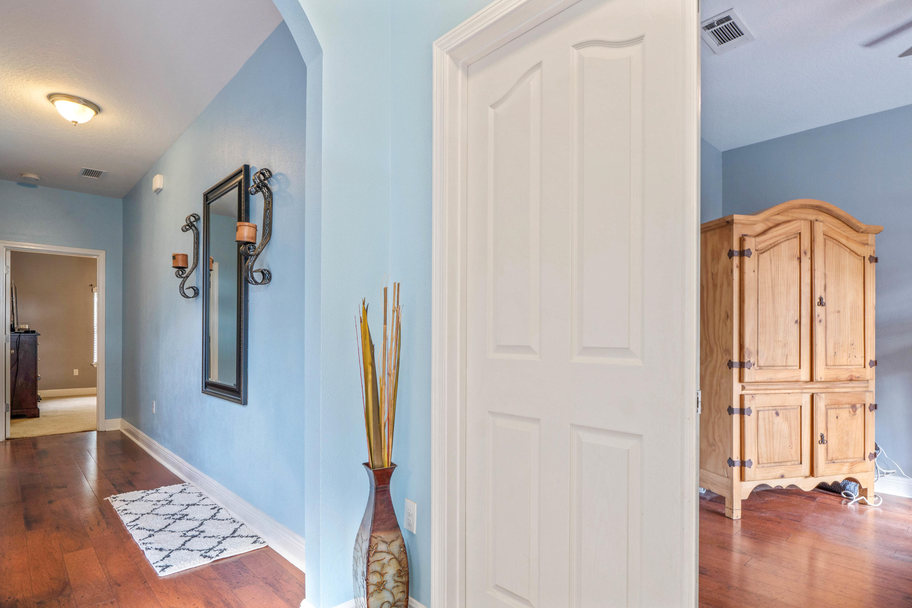 627 Red Fern Road Crestview, FL 32536 - Photo 13 of 29 a view of a hallway with wooden floor and windows