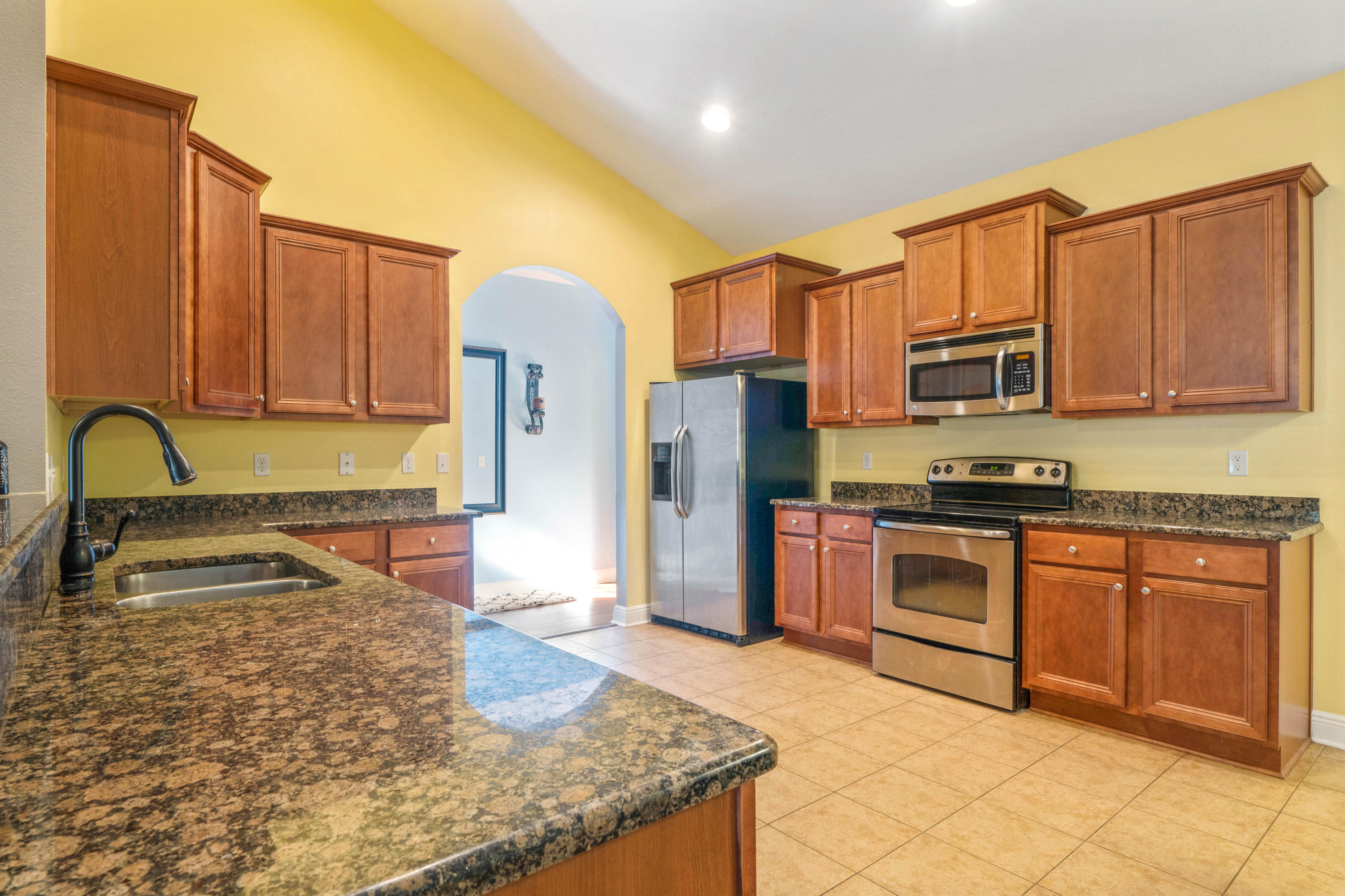 627 Red Fern Road Crestview, FL 32536 - Photo 4 of 29 a kitchen with stainless steel appliances granite countertop a stove a sink dishwasher a refrigerator and a microwave
