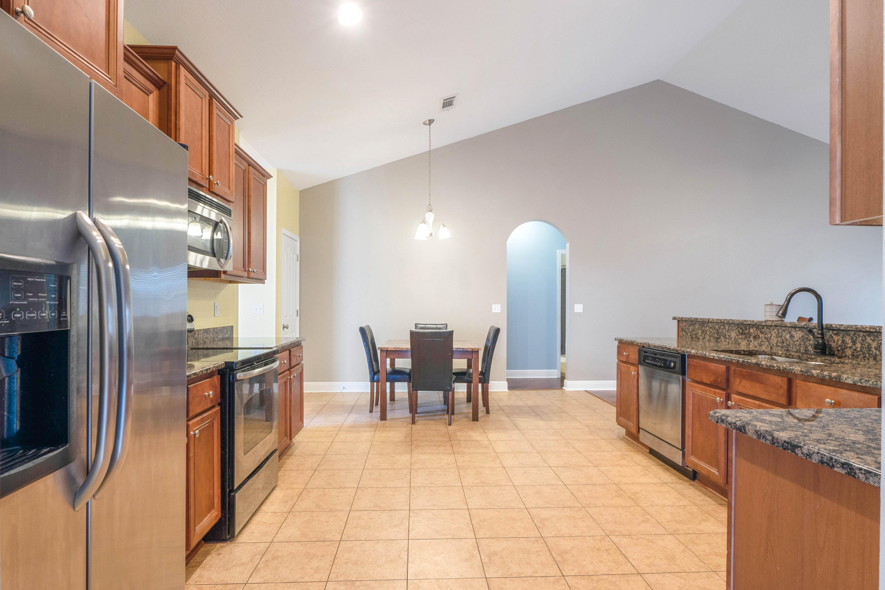 627 Red Fern Road Crestview, FL 32536 - Photo 8 of 29 a kitchen with stainless steel appliances granite countertop a sink and a refrigerator