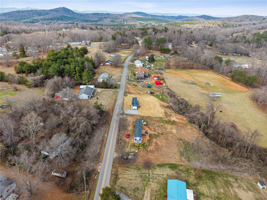 139 Davis Road Easley, SC 29640 - Photo 28 of 34 This elevated view captures the extensive land and surrounding rural community with mountainous vistas.