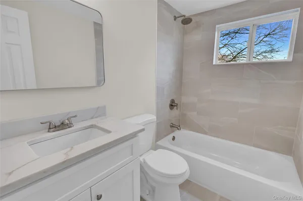 a bathroom with a sink a toilet and bathtub