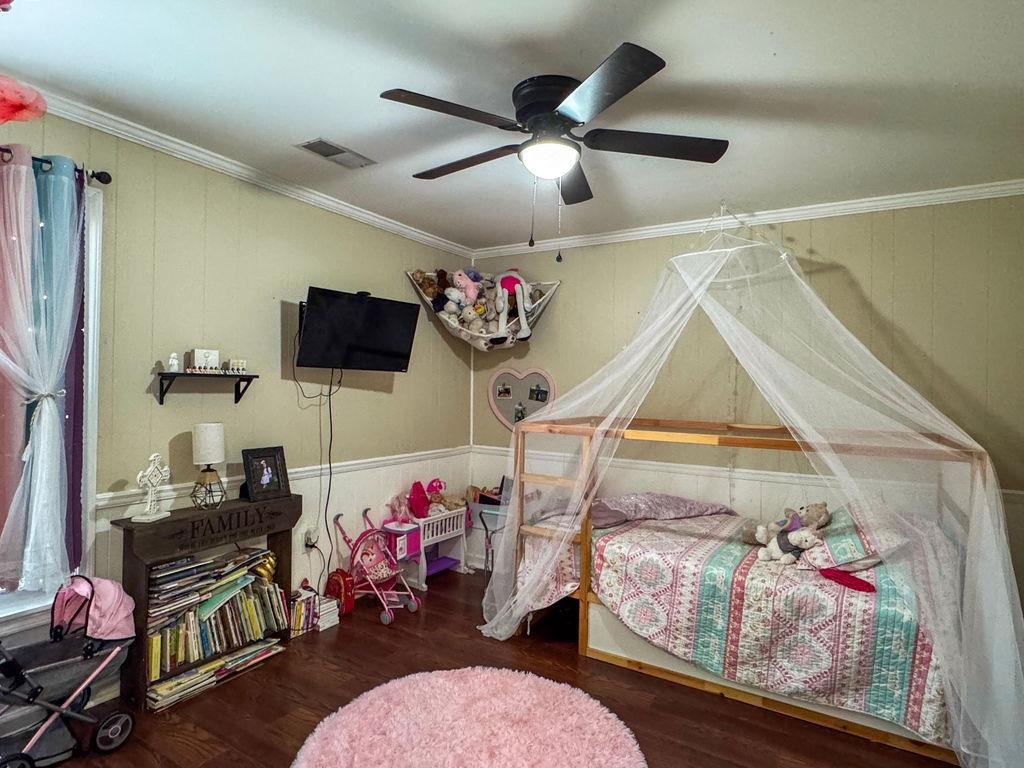 127 Walton Loop Covington, TN 38019 - Photo 25 of 40 a bedroom with furniture a flat screen tv and a window