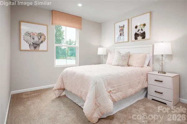 a bedroom with a bed and a painting on the wall