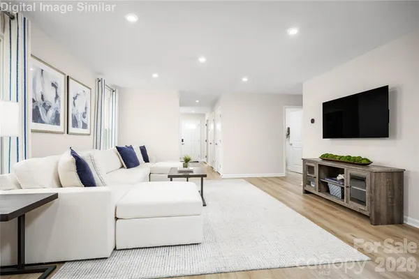 a living room with furniture and a flat screen tv