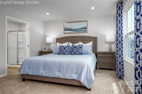 a bedroom with a bed and a painting