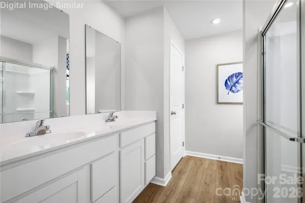 a bathroom with a double vanity sink and a mirror