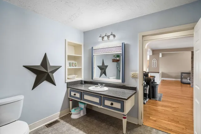 a bathroom with a tub toilet and sink