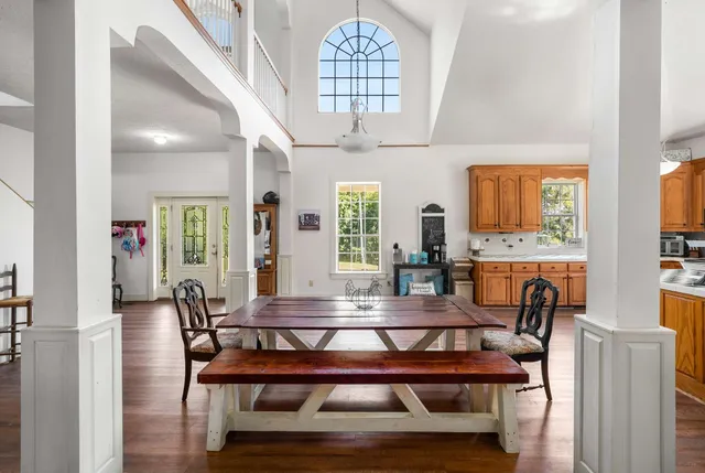 a large kitchen with stainless steel appliances granite countertop a sink a counter space cabinets and a large window