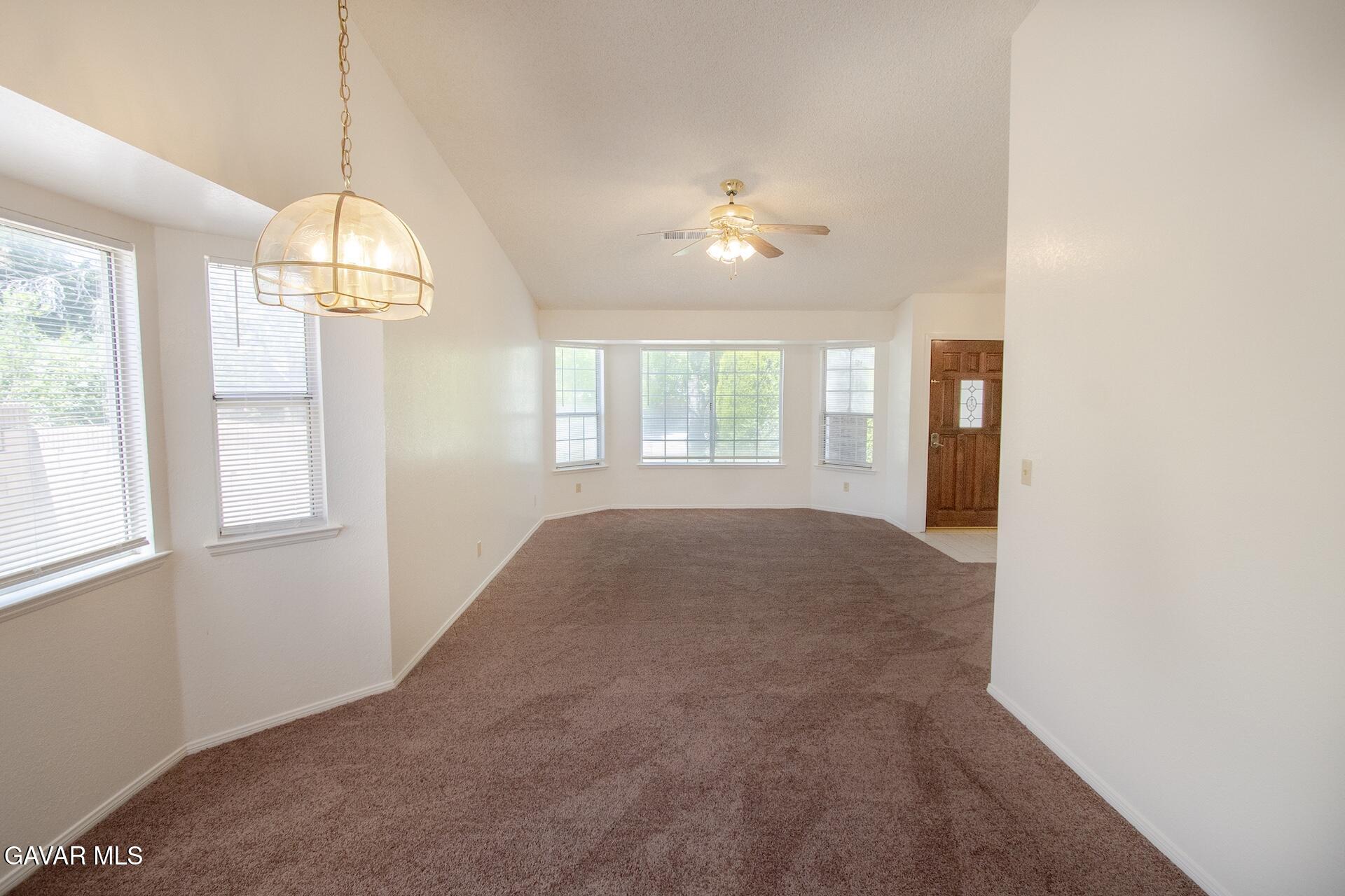 44318 33rd Street West Lancaster, CA 93536 - Photo 12 of 29 a furnished livingroom with windows and chandelier