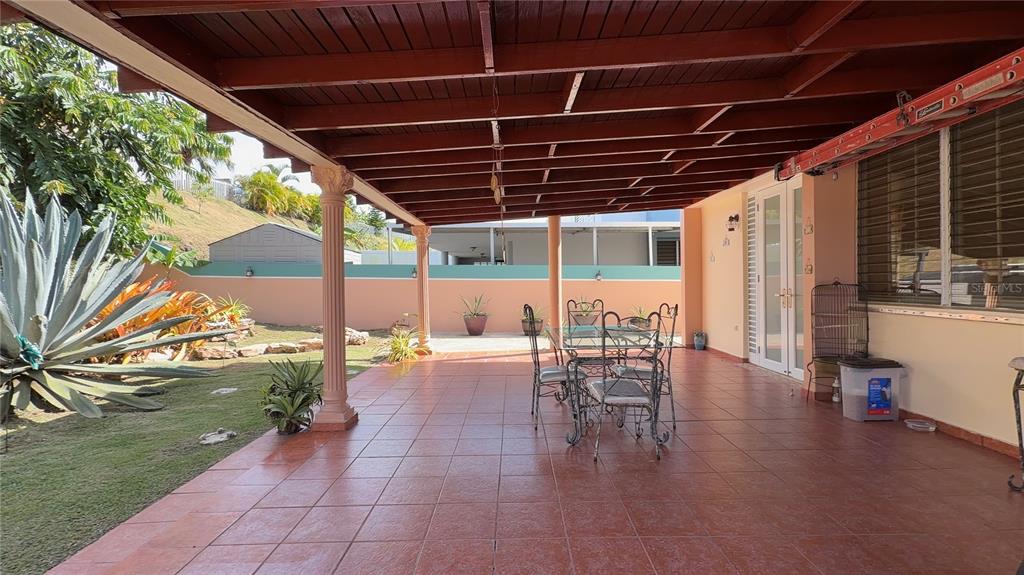 1 St Rio Grande, Unit B6 Rio Grande, PR 00745 - Photo 8 of 47 a view of a patio with table and chairs and potted plants