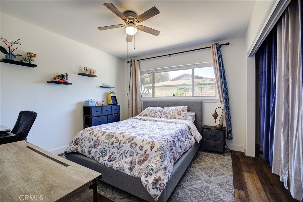 1140 North Belden Avenue Rialto, CA 92376 - Photo 17 of 37 a bedroom with a bed a chandelier and dresser