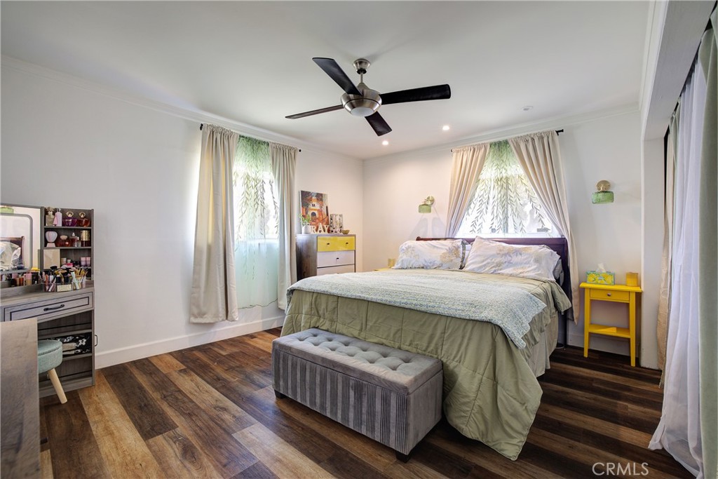 1140 North Belden Avenue Rialto, CA 92376 - Photo 19 of 37 a bedroom with a bed and wooden floor