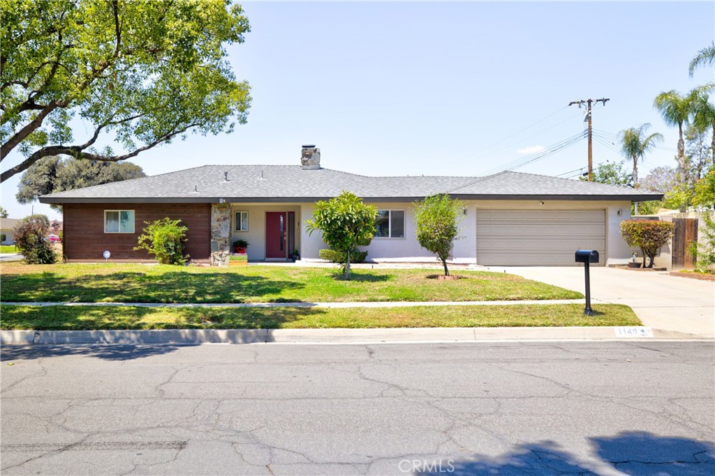 1140 North Belden Avenue Rialto, CA 92376 - Photo 3 of 37 a front view of a house with a yard
