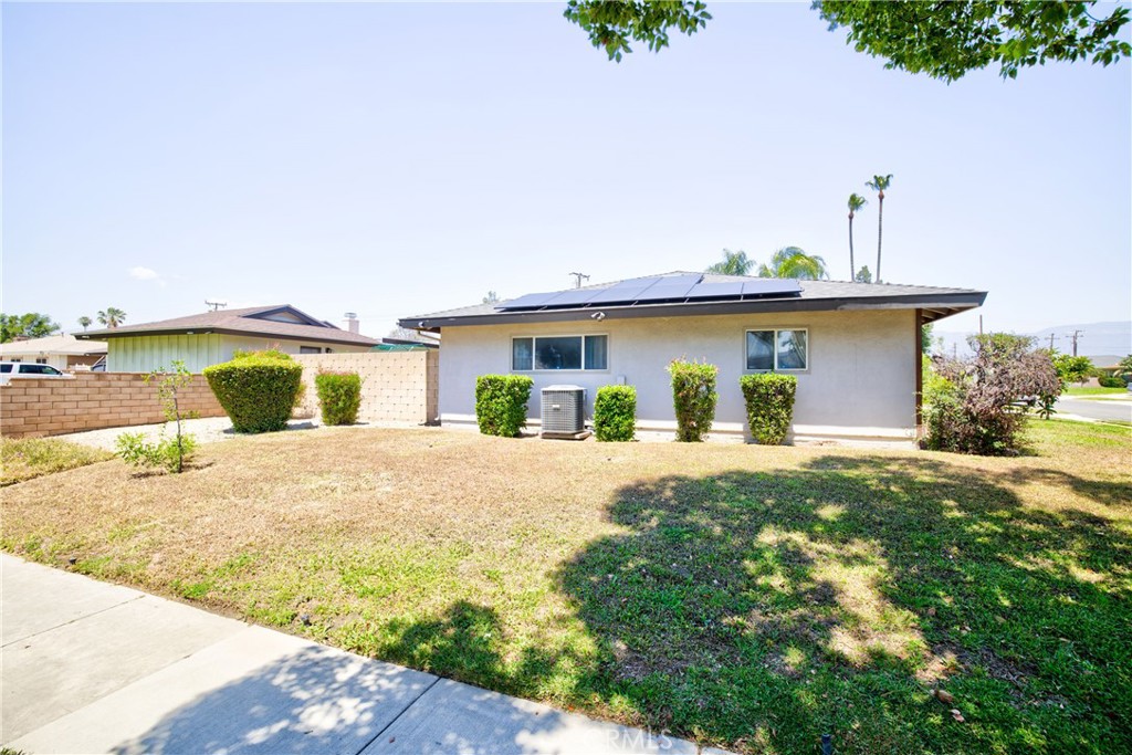 1140 North Belden Avenue Rialto, CA 92376 - Photo 31 of 37 a front view of a house with a yard and garage