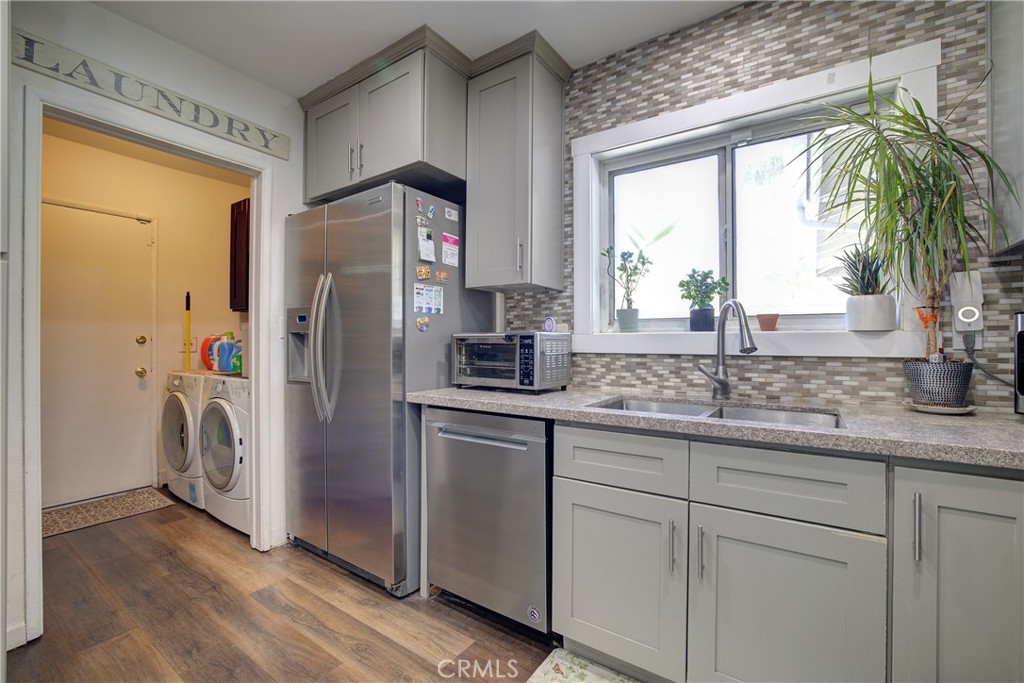 1140 North Belden Avenue Rialto, CA 92376 - Photo 10 of 37 a kitchen with stainless steel appliances granite countertop a refrigerator and a sink