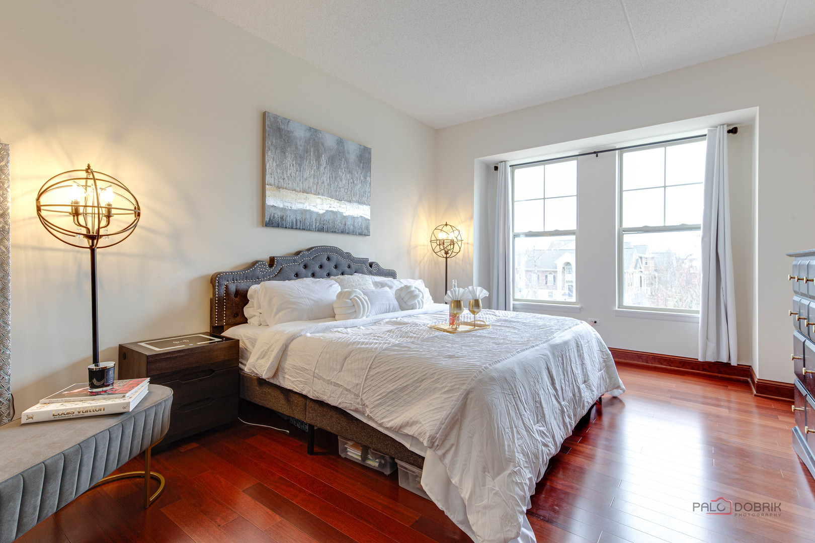 720 Prestwick Lane, Unit 302 Wheeling, IL 60090 - Photo 13 of 23 a bedroom with a bed a chandelier and a window
