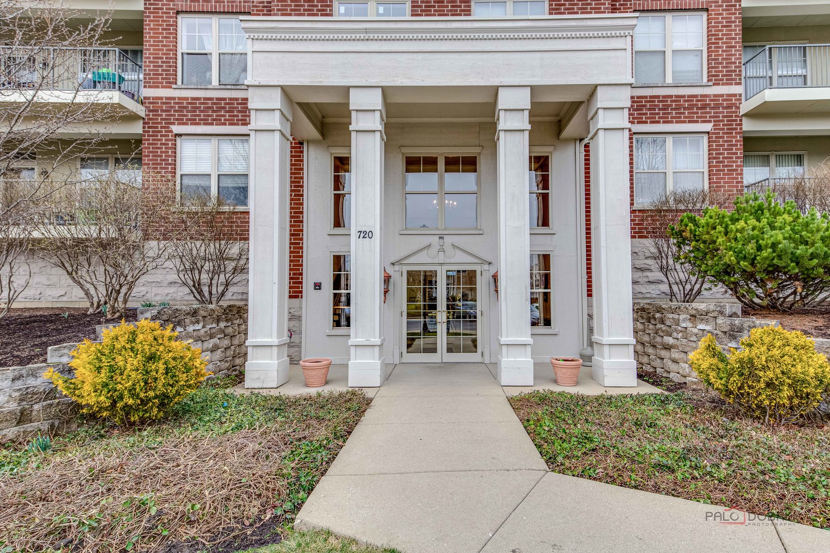 720 Prestwick Lane, Unit 302 Wheeling, IL 60090 - Photo 2 of 23 a front view of a house with a garden