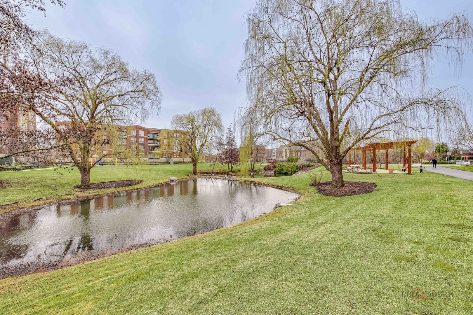 720 Prestwick Lane, Unit 302 Wheeling, IL 60090 - Photo 22 of 23 a view of a lake with houses