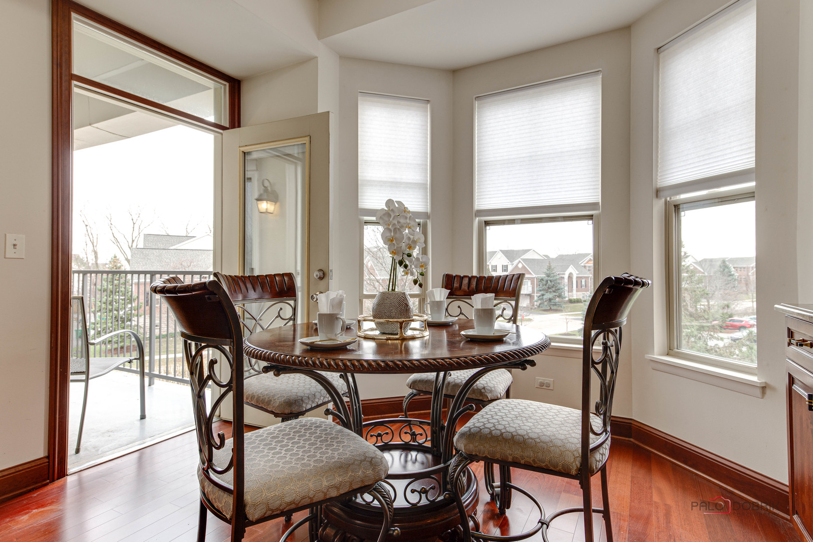720 Prestwick Lane, Unit 302 Wheeling, IL 60090 - Photo 9 of 23 a view of a dining room with furniture window and wooden floor