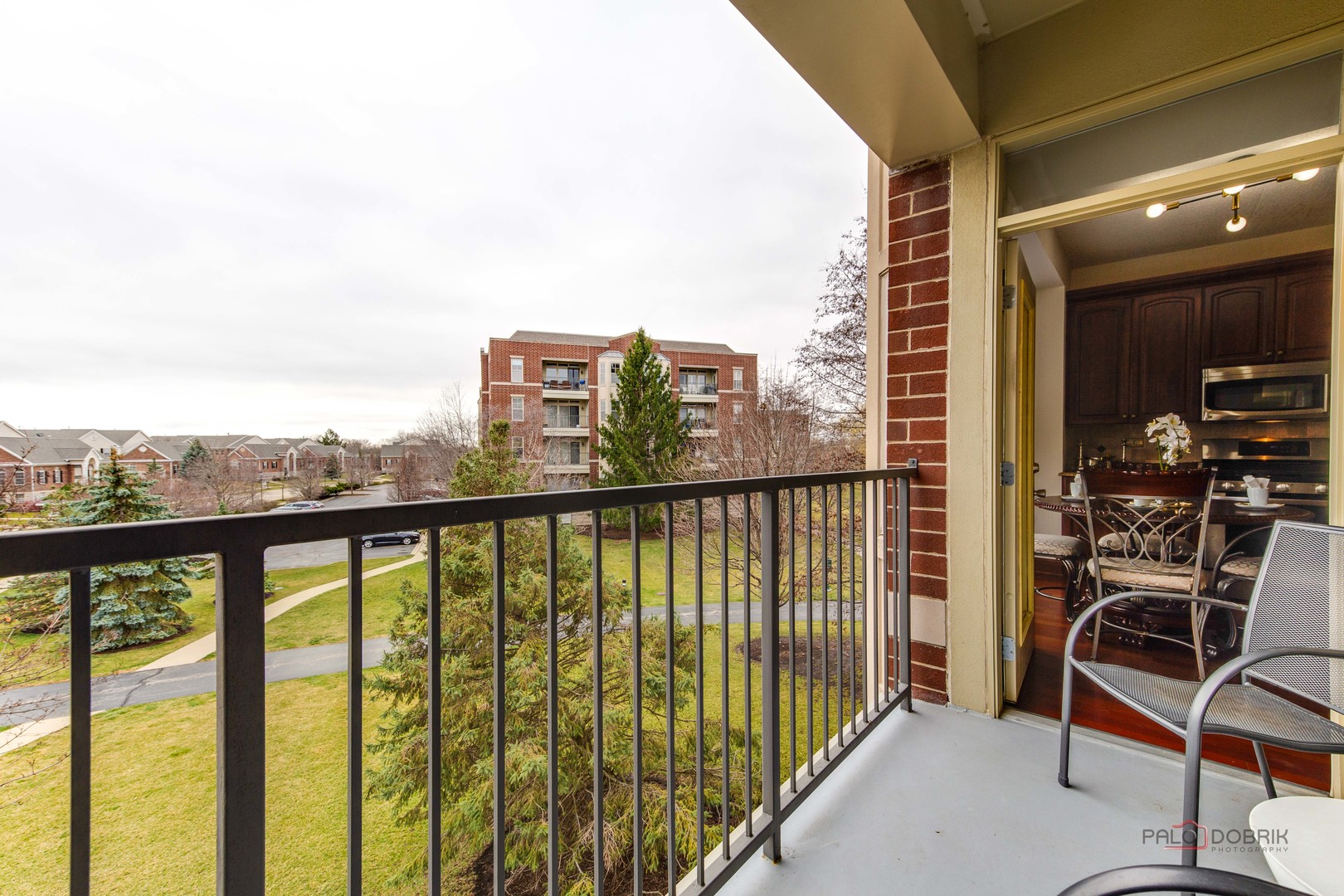 720 Prestwick Lane, Unit 302 Wheeling, IL 60090 - Photo 10 of 23 a view of a balcony with chairs