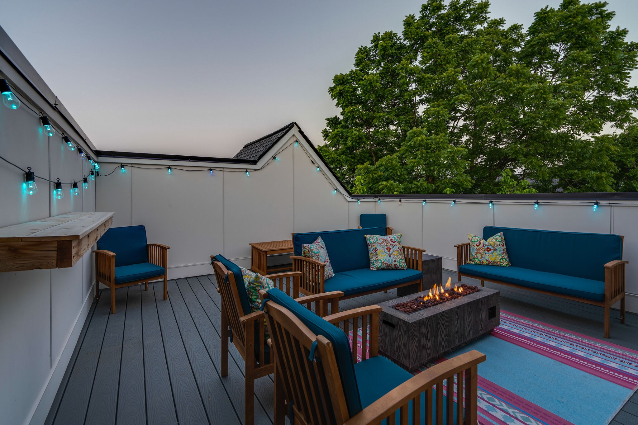 a roof deck with wooden floor and fence
