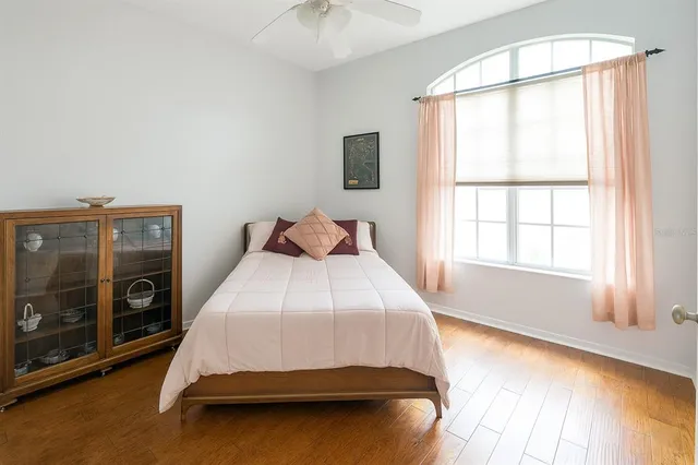 a bedroom with a bed a couch and dresser