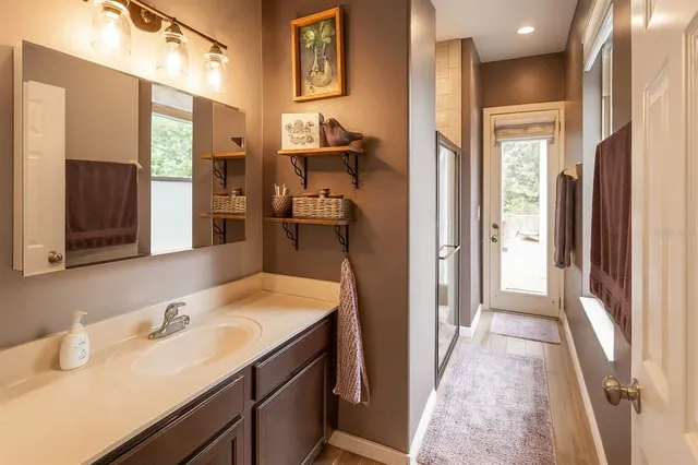 a bedroom with a bed and a lamp on desk