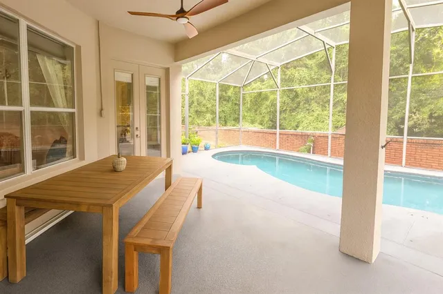 a room with pool table and windows