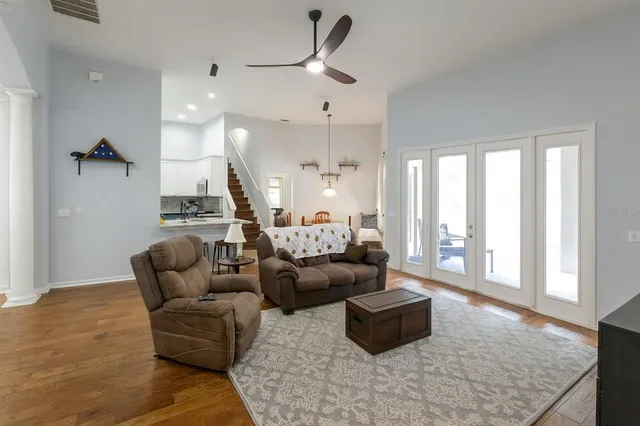 a large kitchen with stainless steel appliances kitchen island granite countertop a refrigerator and a sink