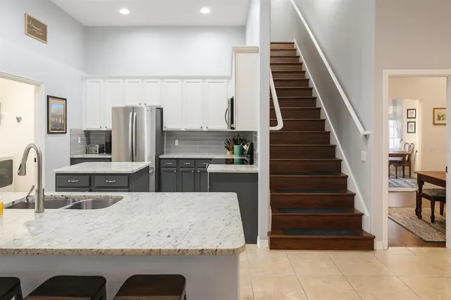 a kitchen with a refrigerator stove and sink
