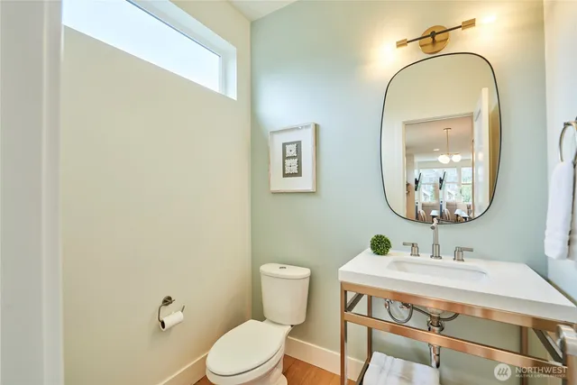 a bathroom with a sink mirror and toilet