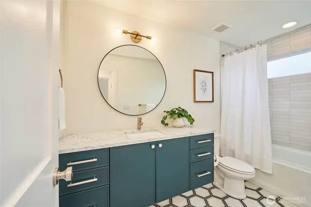 a bathroom with a sink a toilet and a mirror