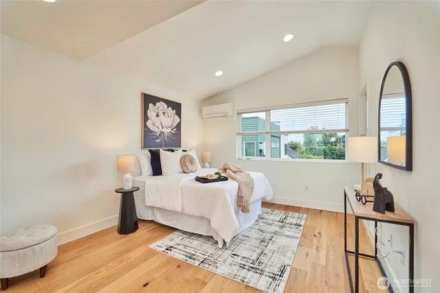a bedroom with a bed and a large window