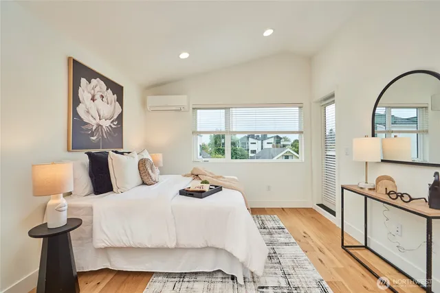 a bedroom with a bed and a painting on the wall