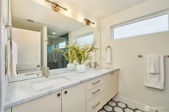 a bathroom with a granite countertop sink and a mirror