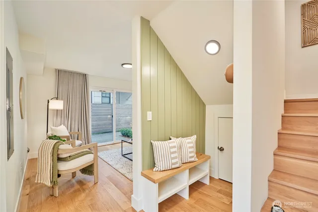 a living room with furniture and a painting on the wall