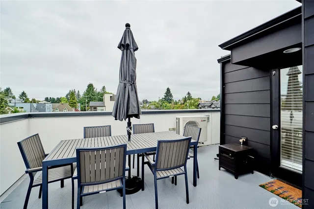 a view of a chairs and table in the balcony