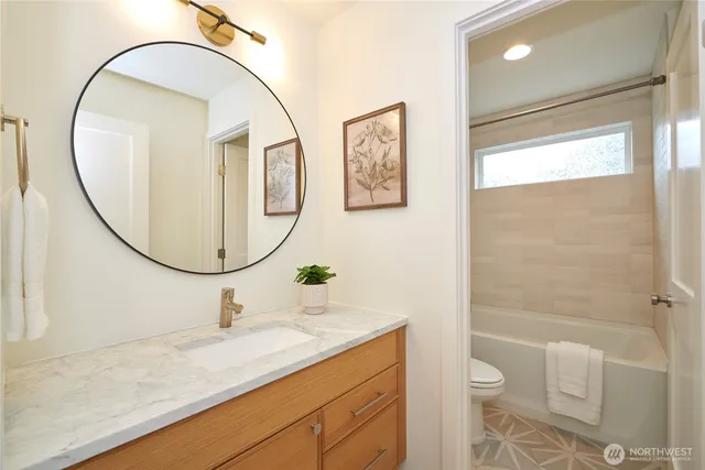 a bathroom with a sink a toilet and a mirror