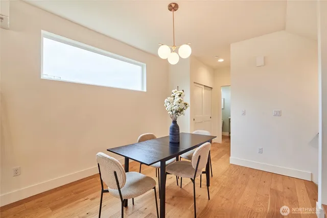 a view of a dining room with a table and chairs