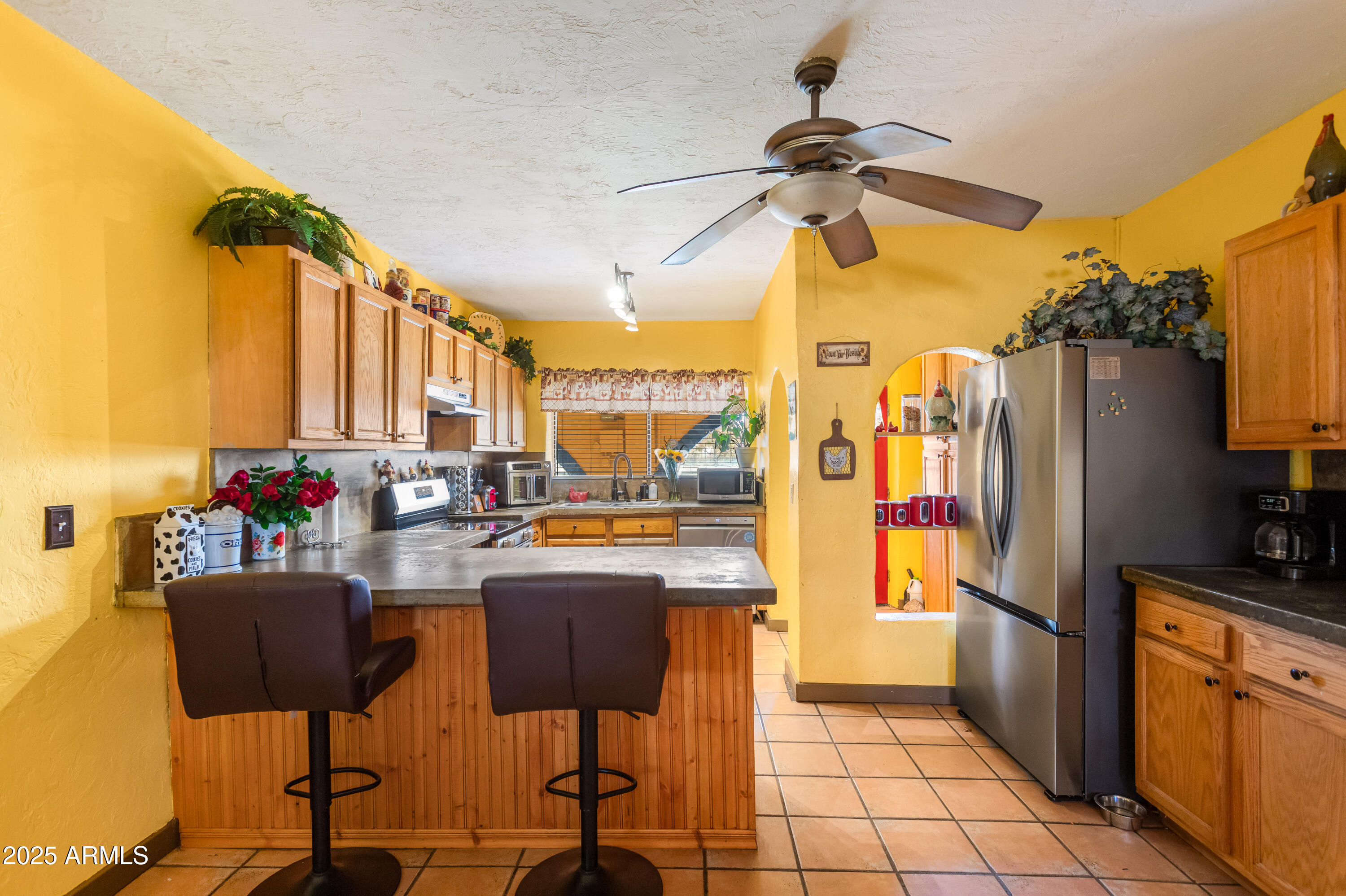 4181 West Double Adobe Road McNeal, AZ 85617 - Photo 13 of 41 a kitchen with stainless steel appliances a refrigerator and a stove top oven