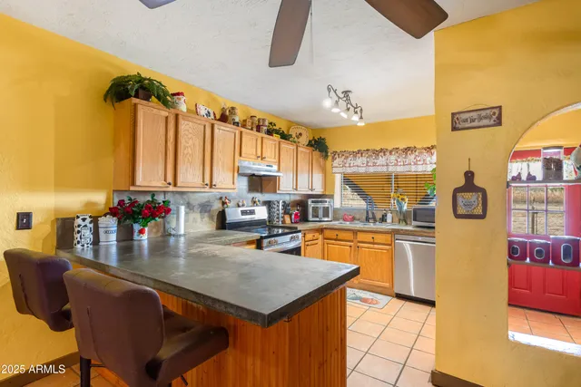 a kitchen with stainless steel appliances granite countertop a stove and a sink