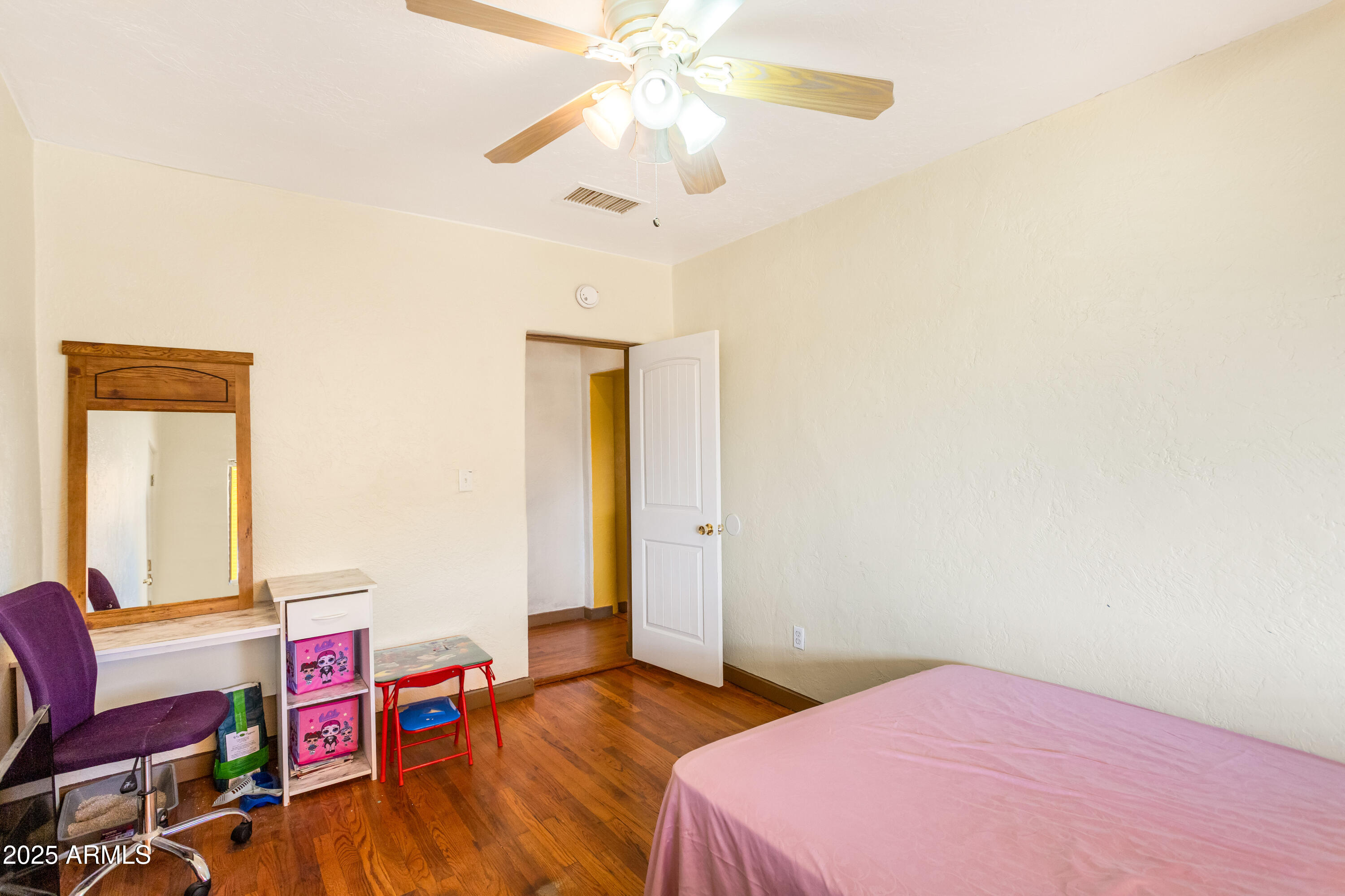 4181 West Double Adobe Road McNeal, AZ 85617 - Photo 17 of 41 a bedroom with a bed and a chandelier