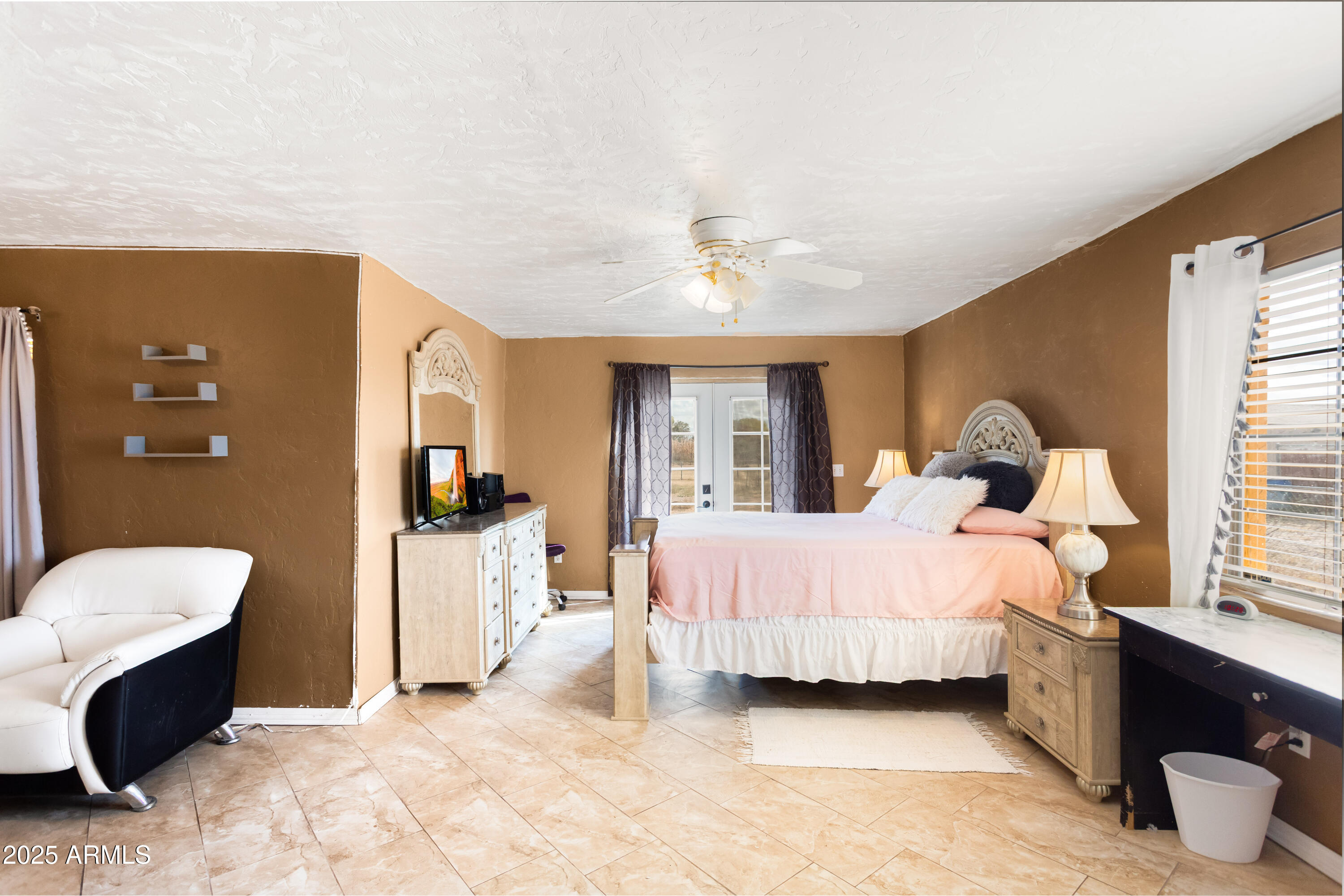 4181 West Double Adobe Road McNeal, AZ 85617 - Photo 20 of 41 a bedroom with a bed and a chandelier
