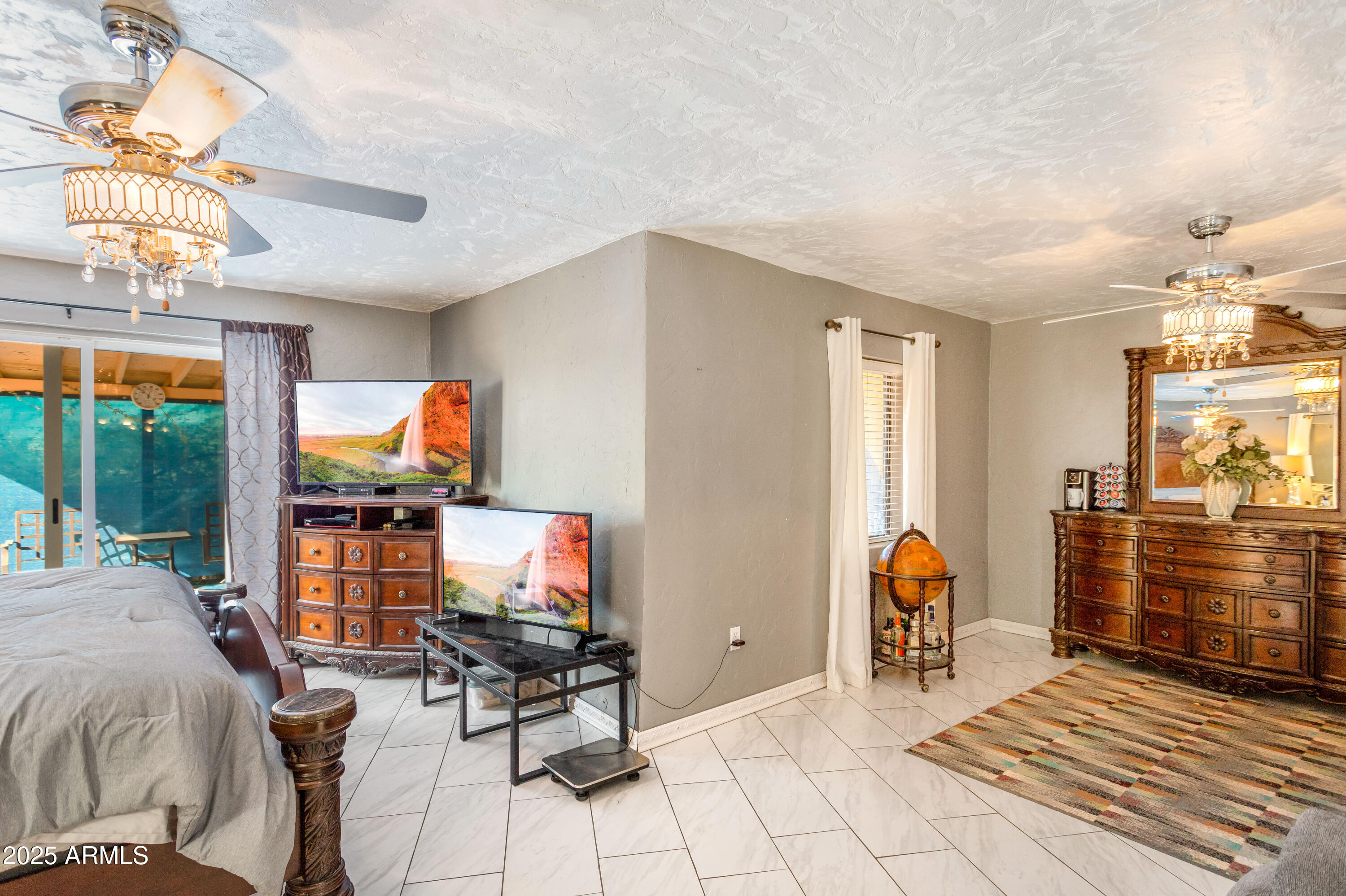 4181 West Double Adobe Road McNeal, AZ 85617 - Photo 23 of 41 a living room with furniture a flat screen tv and a fireplace