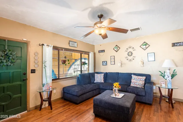 a living room with furniture and wooden floor