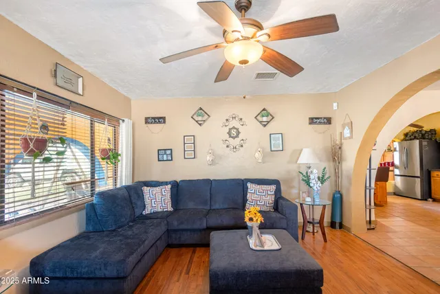 a living room with furniture dining table and a chandelier
